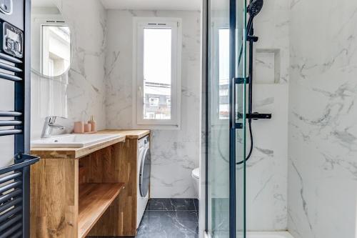 une salle de bain avec douche et lavabo dans l'établissement Intemporel, à Paris