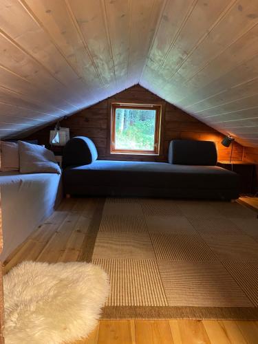 a living room with a couch and a window at Cabin by Oppstrynsvatnet, Hjelle in Stryn