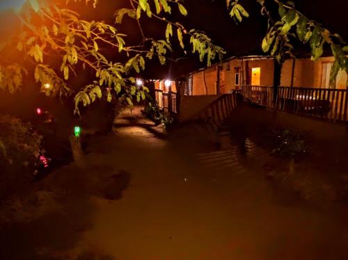 a night view of a house with a green light at Eco Lodge Meemure & Adventure Park in Meemure