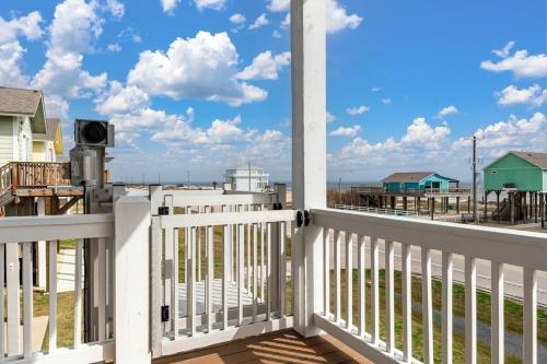 a white porch with a view of the ocean at Fins & Feathers home in Gilchrist