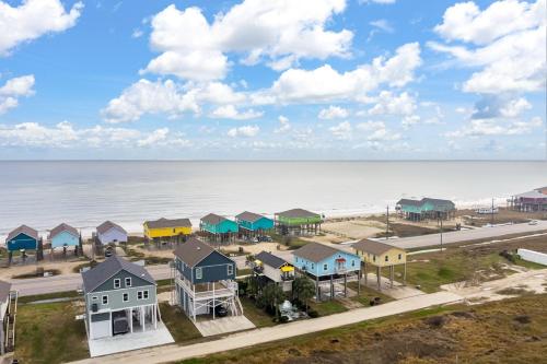 an aerial view of a beach with houses and the ocean at Fins & Feathers home in Gilchrist