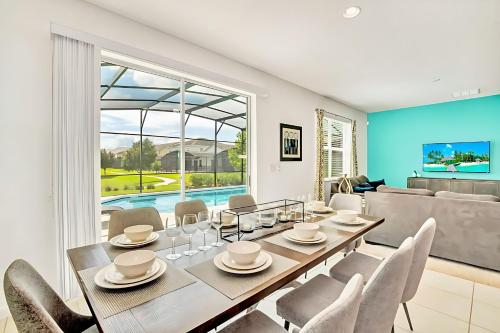 a dining room with a table and chairs at Family Home with Cinema Pool and BBQ Near Disney in Kissimmee
