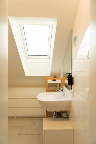 a bathroom with a sink and a skylight at homy Central City Oasis in Dornbirn in Dornbirn
