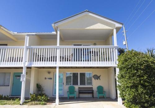 a house with two chairs and a porch at Whispering Sands #2b in Coffeyville