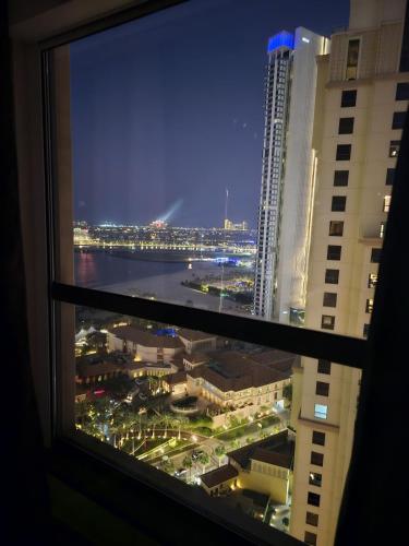 a view of a city at night from a window at Master bedroom in JBR in Dubai