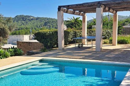 a swimming pool with a table and a picnic table at New! Villa Finca Can Xo Ibiza in Sant Josep de Sa Talaia