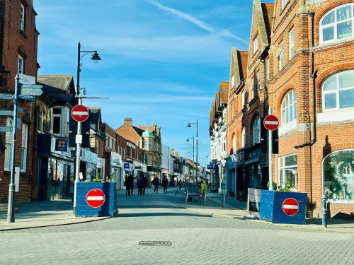 a street with two red and white signs on the street at Unique Apartment with Stunning Views 2B in Felixstowe