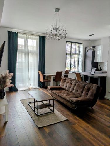 a living room with a couch and a table at Spacious 2-Bedroom Apartment Near City Center in Berlin