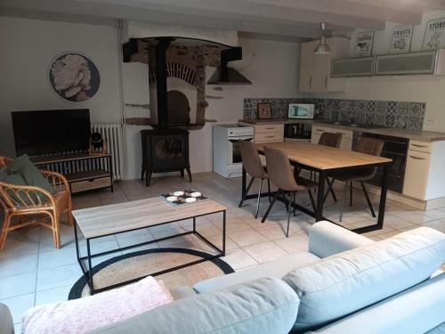 a living room with a couch and a table at Gîte les 3 petits porcelets in Missillac