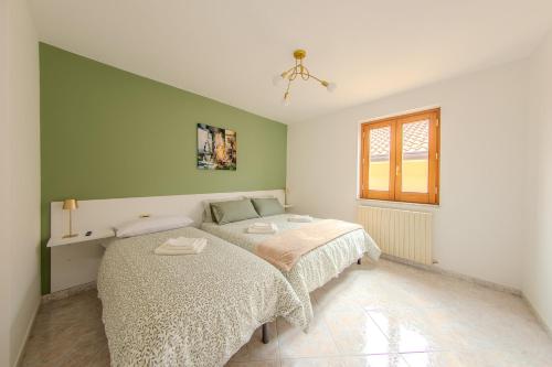 a bedroom with a bed and a window at Casa Vacanze La Piazzetta in Nusco