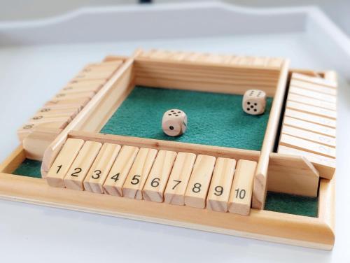 a wooden game of dominoes with two dice at Caedwalla House, Selsey in Selsey