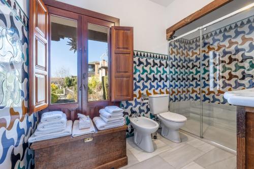 a bathroom with a toilet and a sink at Carmen de los Moriscos - Alhambra views in Granada