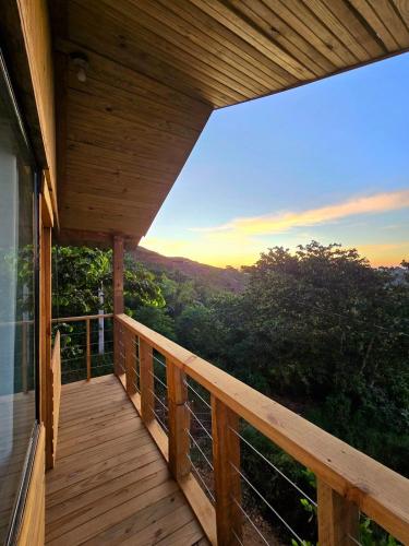 a wooden deck with a view of the mountains at Mountain refuge - Cabin with wonderful views! in La Búcara