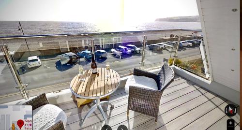 a balcony with a table and chairs on a cruise ship at Mariners Hotel in Seaton