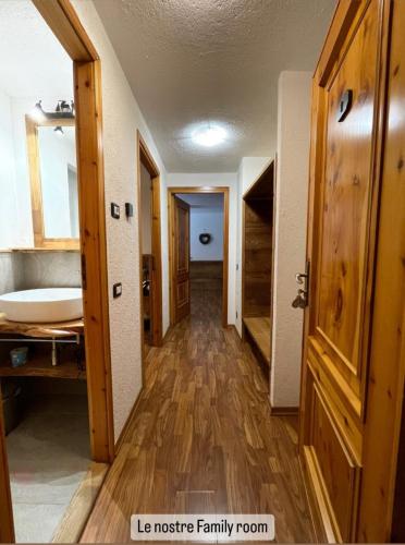 a hallway of a house with a bathroom and a sink at Hotel Coeur Du Village in La Thuile