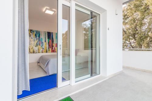 a room with sliding glass doors leading to a bedroom at Villa Mary in Olbia