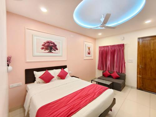 a bedroom with a large bed and a blue ceiling at Ofra Garden in Puducherry