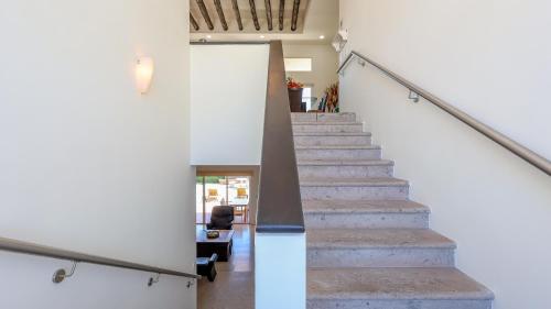 a staircase in a house with a white wall at A Wave FROM IT ALL in Las Conchas
