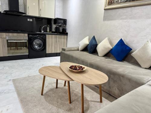 a living room with a couch and a table at Studio Appartement MIRAMAR in Mohammedia