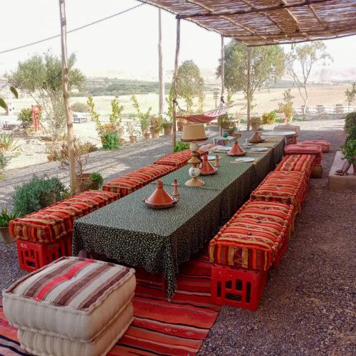 a row of tables with red seats at Ngayan Camp in Marrakech
