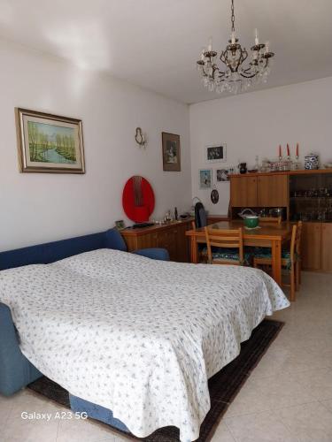 a bedroom with a bed and a dining room at Diva home monfy in Monfalcone