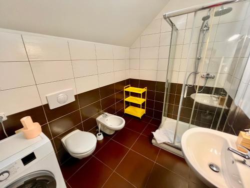 a bathroom with a toilet and a sink and a shower at Riverbridge Apartments Prague in Prague