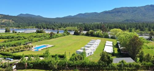 an aerial view of a large estate with a swimming pool on a grassy hill at Achibueno Lodge in Linares