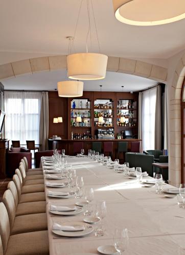 a long dining room with a long table with wine glasses at Casa Anamaria Hotel in Ollers
