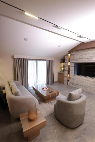 a living room with two couches and a coffee table at Heaven Prestige Hotel in Jounieh
