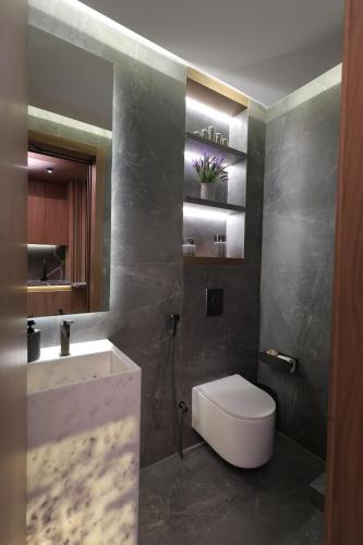 a bathroom with a white toilet and a sink at Heaven Prestige Hotel in Jounieh