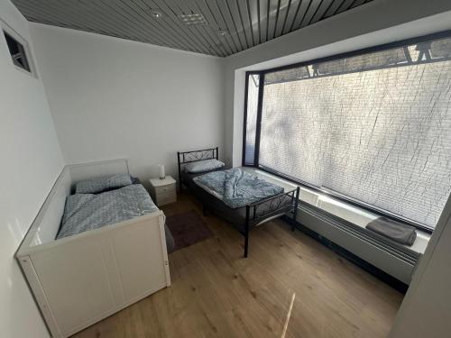 an empty room with two beds and a window at Zauberblick in Lindenfels