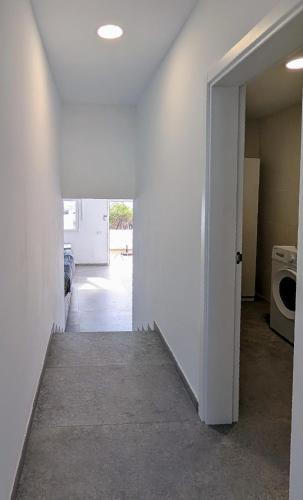 a hallway of a house with a door open at Casa Sol. Tu refugio de relax en Lanzarote in Tías