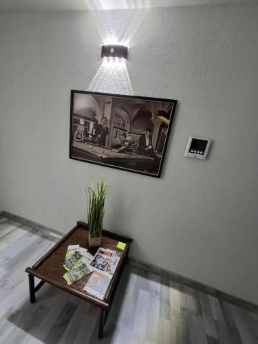 a living room with a table and a picture on the wall at GRooms in Gemmrigheim