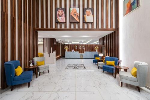 a lobby with blue chairs and a waiting room at The Palaces Hotel Suites - Wadeen in Khamis Mushayt