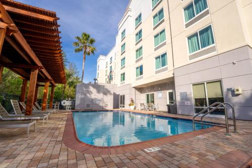 a swimming pool in front of a building at Fairfield Inn & Suites Jacksonville Butler Boulevard in Jacksonville