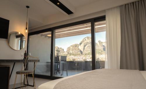 a bedroom with a view of the mountain at Mirabilis Boutique Hotel by Panel Hospitality in Kalabaka
