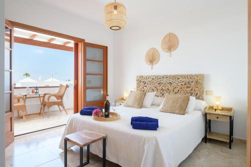 a bedroom with a bed with a view of the ocean at VILLA ERIC with a private stunning heated pool in Puerto del Carmen