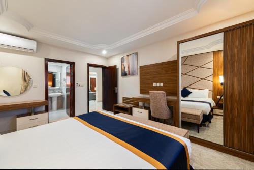 a hotel room with a bed and a desk at The Palaces Hotel Suites - Wadeen in Khamis Mushayt