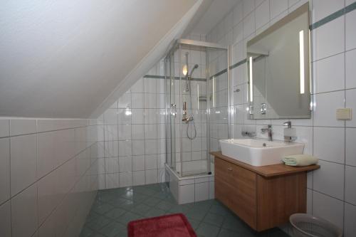 a white bathroom with a sink and a shower at Weingut Schwarzl in Ratsch an der Weinstraße