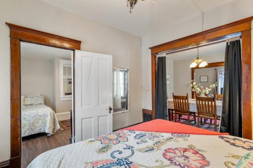 a bedroom with a bed and a dining room at Stowaway Lower Deck in Sturgeon Bay
