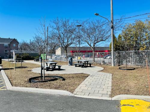 a park with picnic tables and a fence at Econo Lodge Hotel Brossard in Brossard