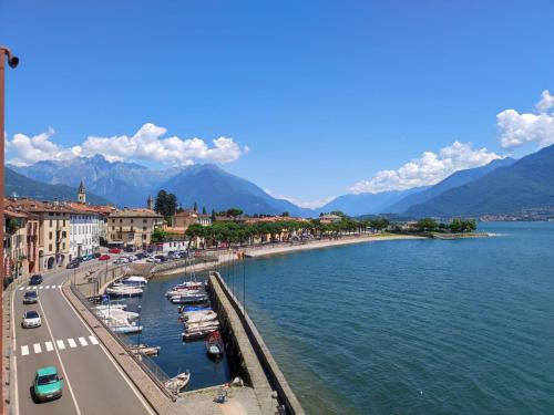 a city with boats in the water next to a street at Apartment Lavarello by Interhome in Domaso
