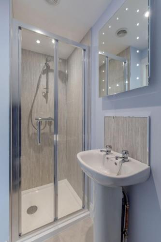 a bathroom with a sink and a shower at Holiday Home Portpatrick House by Interhome in Portpatrick