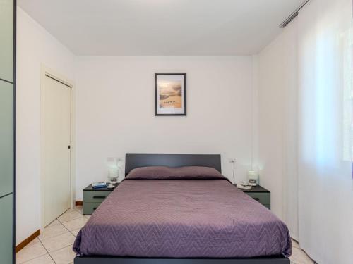 a bedroom with a purple bed and two night stands at Apartment Jai Jai by Interhome in Colico