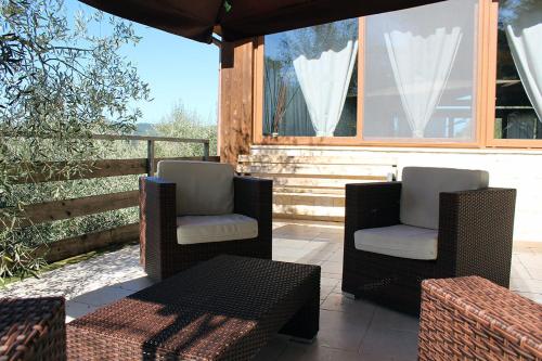 two chairs and a table on a patio at Agriturismo Fara del Falco in Vieste
