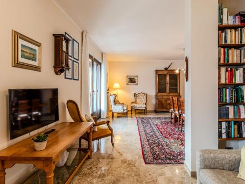 a living room with a table and a tv at Apartment Casa Luli by Interhome in Gravedona