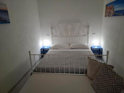 a bedroom with a white bed with two night stands at Il vigneto in Vernazza