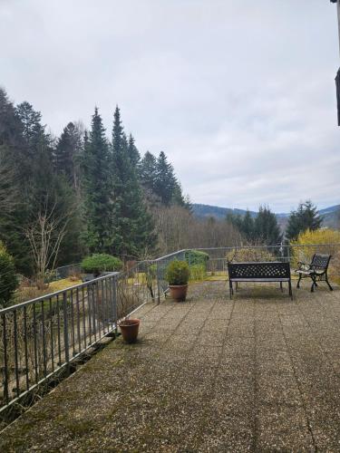 a bench sitting on a patio next to a fence at Triberg Falls Hideaway - Apartment 35 in Triberg