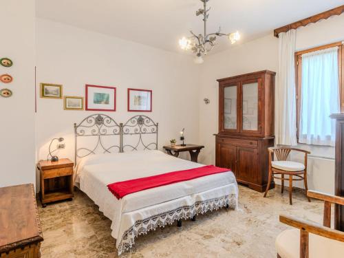 a bedroom with a bed and a table and a chair at Apartment Casa Luli by Interhome in Gravedona
