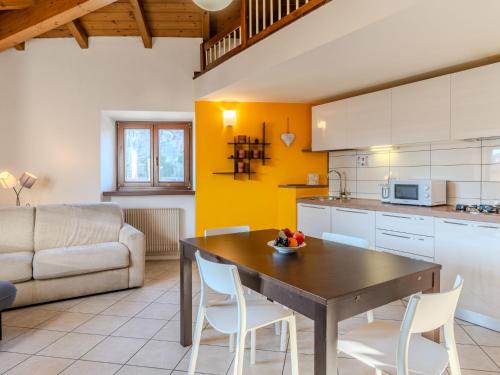 a kitchen with a table and chairs and a couch at Apartment Lidia by Interhome in Arco